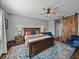 Stylish main bedroom featuring an accent chair, ceiling fan, bedside tables, and decor at 12492 Eastpointe Dr, Dade City, FL 33525