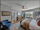 Spacious main bedroom with an accent chair, ceiling fan, dresser, and natural light at 12492 Eastpointe Dr, Dade City, FL 33525