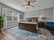 Cozy main bedroom with a decorative ceiling fan, area rug, and natural light at 12492 Eastpointe Dr, Dade City, FL 33525