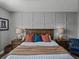Elegant main bedroom with a paneled accent wall and bedside tables with lamps at 12492 Eastpointe Dr, Dade City, FL 33525