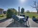 Inviting outdoor patio featuring a dining set and a striped umbrella, ideal for relaxing and entertaining outdoors at 12492 Eastpointe Dr, Dade City, FL 33525