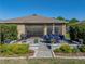 Relaxing outdoor patio with a dining set, grill, and fire pit in a meticulously landscaped backyard at 12492 Eastpointe Dr, Dade City, FL 33525