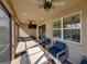 Spacious screened patio with ceiling fans, outdoor seating, and a wall mounted television at 12492 Eastpointe Dr, Dade City, FL 33525