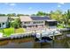 Aerial view of the property with a dock, screened-in porch, and solar panels at 1432 50Th Ne Ave, St Petersburg, FL 33703