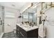 Modern bathroom featuring a double vanity, marble counters, updated fixtures and tile floor at 1432 50Th Ne Ave, St Petersburg, FL 33703