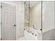 Bathroom features shower with glass partition and soaking tub combination at 1432 50Th Ne Ave, St Petersburg, FL 33703