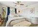 Bright bedroom featuring a crystal ceiling fan, accent pillows and white closet at 1432 50Th Ne Ave, St Petersburg, FL 33703