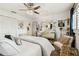 Bright bedroom featuring a crystal ceiling fan, accent pillows, and decorative wall art at 1432 50Th Ne Ave, St Petersburg, FL 33703