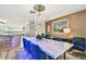 Formal dining room features a statement chandelier and marble-top dining table at 1432 50Th Ne Ave, St Petersburg, FL 33703