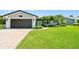 Beautifully landscaped home with mature palms and a well-manicured lawn and a two-car garage at 1432 50Th Ne Ave, St Petersburg, FL 33703