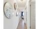 Hallway with wood floors, decorative mirrors, and multiple doorways at 1432 50Th Ne Ave, St Petersburg, FL 33703