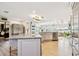 Spacious open kitchen features a center island with seating, stainless steel appliances and wood floors at 1432 50Th Ne Ave, St Petersburg, FL 33703