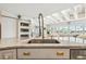 The updated kitchen boasts designer faucet, stainless appliances, and an open layout at 1432 50Th Ne Ave, St Petersburg, FL 33703
