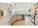 Open kitchen boasts custom cabinets, stainless appliances, and marble countertops at 1432 50Th Ne Ave, St Petersburg, FL 33703