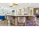 The gorgeous kitchen island has seating and statement lighting, open to the living area at 1432 50Th Ne Ave, St Petersburg, FL 33703