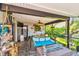 The lanai features a cozy seating area with a gas fireplace and views of the lush greenery at 1432 50Th Ne Ave, St Petersburg, FL 33703