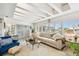 Bright living room offers natural light from large windows and beamed ceilings at 1432 50Th Ne Ave, St Petersburg, FL 33703