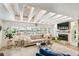 Bright living room with beamed ceilings, large windows, and a fireplace at 1432 50Th Ne Ave, St Petersburg, FL 33703