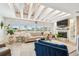 Cozy living room with beamed ceilings, large windows, and a fireplace at 1432 50Th Ne Ave, St Petersburg, FL 33703
