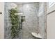 Shower featuring decorative stone-look tile and updated fixtures at 1432 50Th Ne Ave, St Petersburg, FL 33703