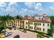Aerial view of the building with palm trees, red brick parking lot, and downtown skyline at 1501 W Horatio St # 101, Tampa, FL 33606