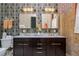 Bathroom with a double vanity, elegant wallpaper, and vintage-inspired lighting at 1501 W Horatio St # 101, Tampa, FL 33606