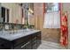 Bathroom with a double vanity, exposed brick, and marble countertops at 1501 W Horatio St # 101, Tampa, FL 33606