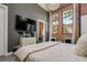 Bedroom with a TV, exposed brick, large windows, and cozy seating area at 1501 W Horatio St # 101, Tampa, FL 33606
