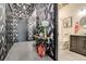 Hallway leading into a full bathroom with stylish heron wallpaper, offering a unique and elegant design at 1501 W Horatio St # 101, Tampa, FL 33606