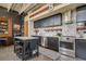 Modern kitchen with stainless steel appliances, dark cabinetry, and breakfast bar seating at 1501 W Horatio St # 101, Tampa, FL 33606