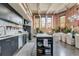 Open-concept kitchen with brick walls, an island, stainless appliances, and lots of natural light at 1501 W Horatio St # 101, Tampa, FL 33606