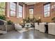 Bright living room featuring exposed brick, comfortable seating, and stylish decor at 1501 W Horatio St # 101, Tampa, FL 33606