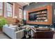Comfortable living room with exposed brick, stylish decor, and large picture window at 1501 W Horatio St # 101, Tampa, FL 33606