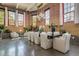 Living room with large dining table, exposed brick, and bright lighting at 1501 W Horatio St # 101, Tampa, FL 33606