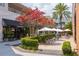 Charming outdoor seating area with umbrellas, greenery, and views of local shops, ideal for relaxing at 1501 W Horatio St # 101, Tampa, FL 33606