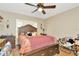 This bedroom offers wood-look flooring, a ceiling fan, and a large window at 15234 Scanio Dr, Spring Hill, FL 34610