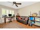 This bedroom offers a ceiling fan, hard flooring, and natural light at 15234 Scanio Dr, Spring Hill, FL 34610