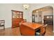Dining room with tile floor, china cabinet, dining table, and view to the front entry at 15234 Scanio Dr, Spring Hill, FL 34610