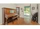 Entryway featuring hardwood floors, piano and view into the outdoor screened-in porch at 15234 Scanio Dr, Spring Hill, FL 34610