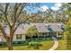 Beautiful single-story home featuring a screened-in porch and a well-manicured lawn at 15234 Scanio Dr, Spring Hill, FL 34610