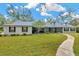 Inviting single-story home with well-maintained lawn and screened porch at 15234 Scanio Dr, Spring Hill, FL 34610