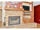 Brick fireplace with wooden mantel and built-in shelving in living area at 15234 Scanio Dr, Spring Hill, FL 34610