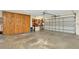 Spacious garage featuring ample storage, a work bench, and a large door for convenient access at 15234 Scanio Dr, Spring Hill, FL 34610
