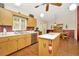 Traditional kitchen with wooden cabinets, a central island, stainless steel appliances, and view to dining area at 15234 Scanio Dr, Spring Hill, FL 34610