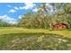 Extensive property showcasing a large field with trees, including a barn at the edge at 15234 Scanio Dr, Spring Hill, FL 34610