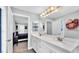 Bright bathroom featuring double sinks with white cabinets, a large mirror, and modern decor at 1901 Paddock Dr, Plant City, FL 33566