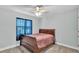 Cozy bedroom with a wood sleigh bed, ceiling fan, and natural light from the window at 1901 Paddock Dr, Plant City, FL 33566