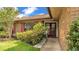 Charming entryway featuring a brick facade, colorful shutters, and a landscaped garden area at 1901 Paddock Dr, Plant City, FL 33566
