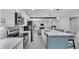 Open kitchen featuring stainless steel appliances, a blue island, and a seamless transition into the living area at 1901 Paddock Dr, Plant City, FL 33566