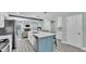 Bright kitchen island with seating and stainless steel appliances, offering open layout to living space at 1901 Paddock Dr, Plant City, FL 33566